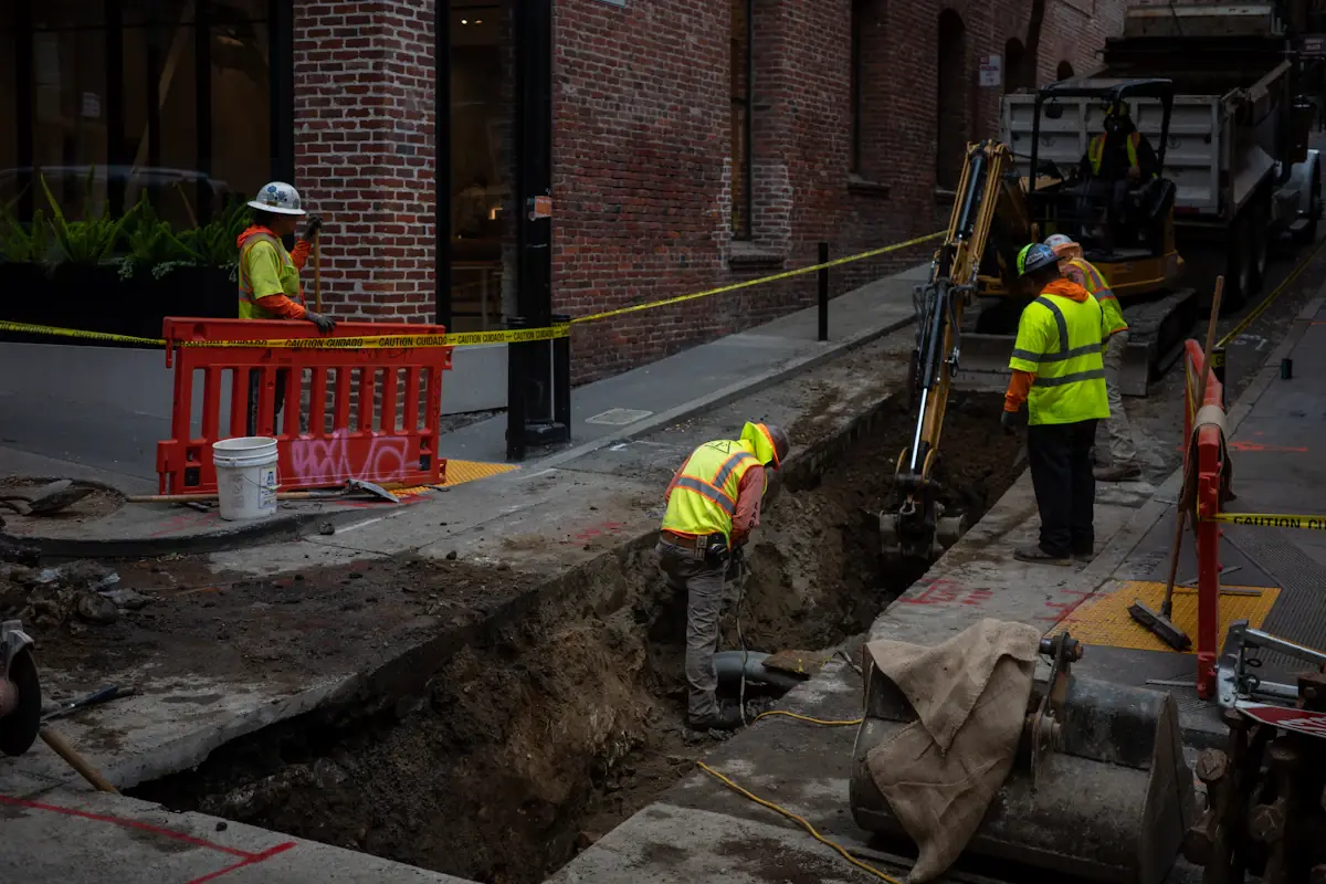 Work crew excavating a trench to reach a buried water line
