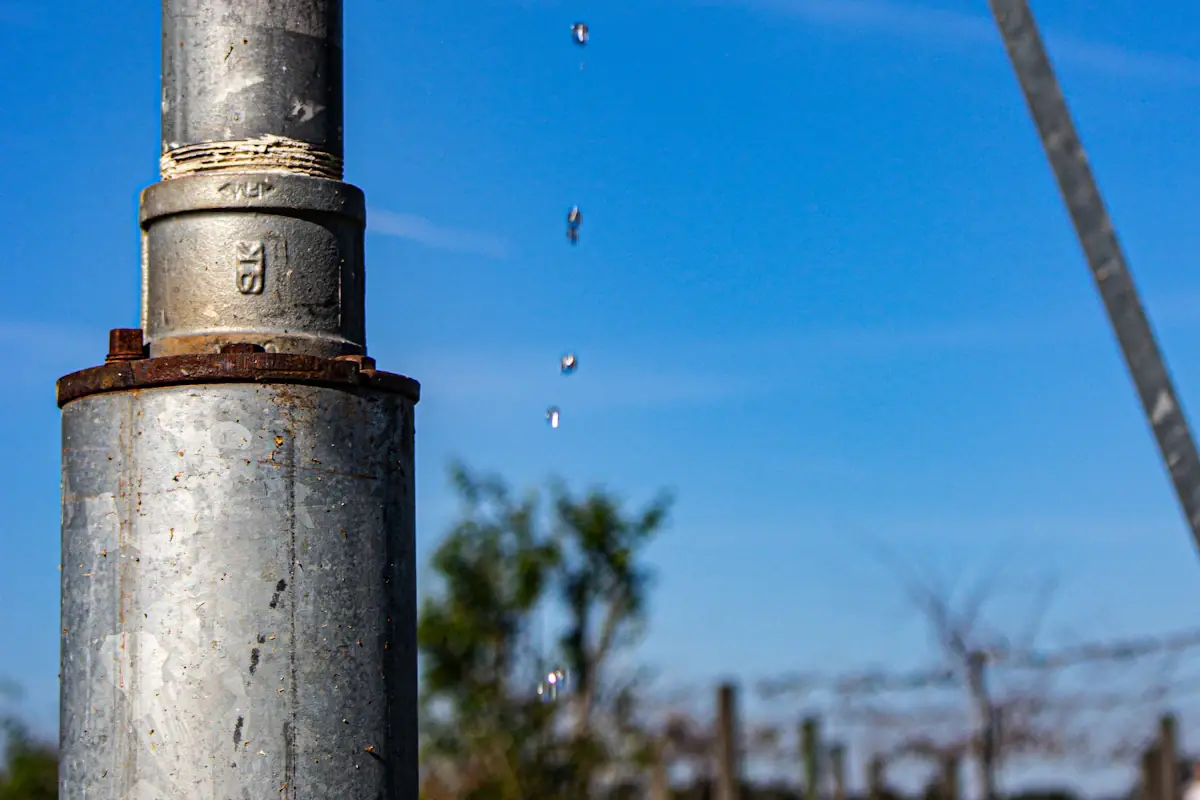 Water dripping from a leaking outdoor supply pipe
