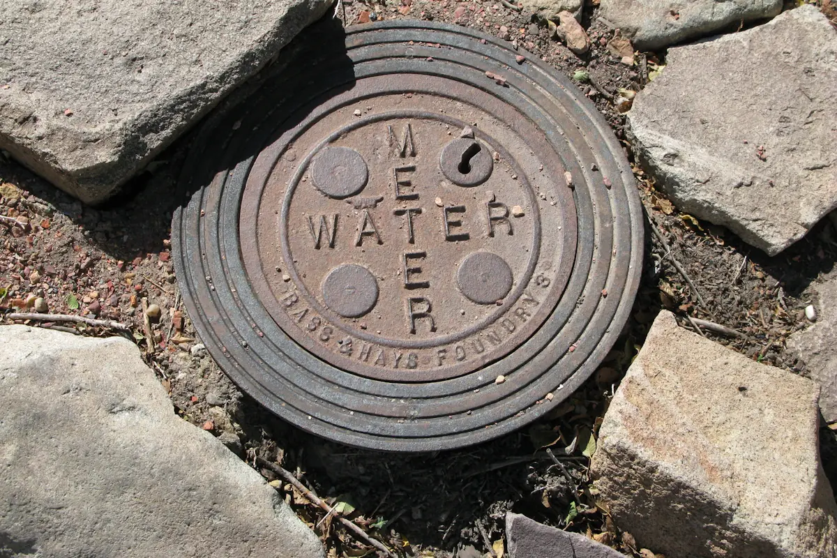 Cast-iron water meter box cover set in the ground